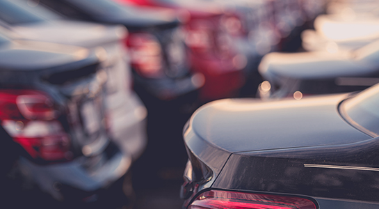 Rows of brand new cars parked in a lot