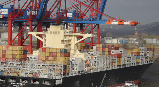 A container ship is loaded by Crain.