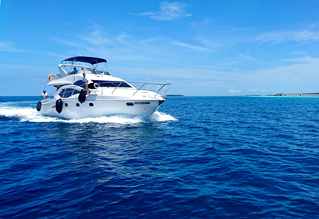 A white yacht sailing in blue seas during daytime